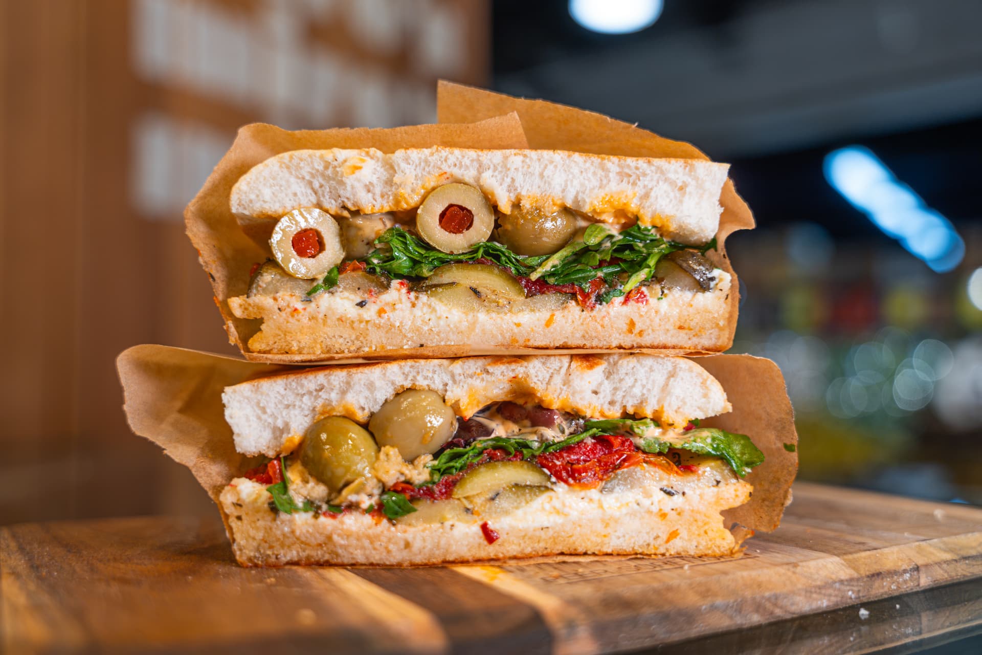 Vegetarian focaccia sandwich stacked and wrapped.
