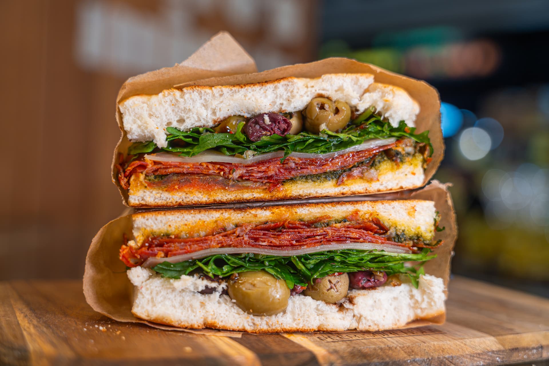Sopressa Delight focaccia sandwich stacked and wrapped.